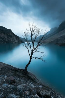 A black-toned bright photograph of lakeside, valley, dam.