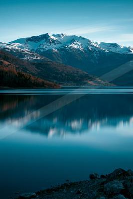 A blue hour long exposure water scene of lake, reflection.