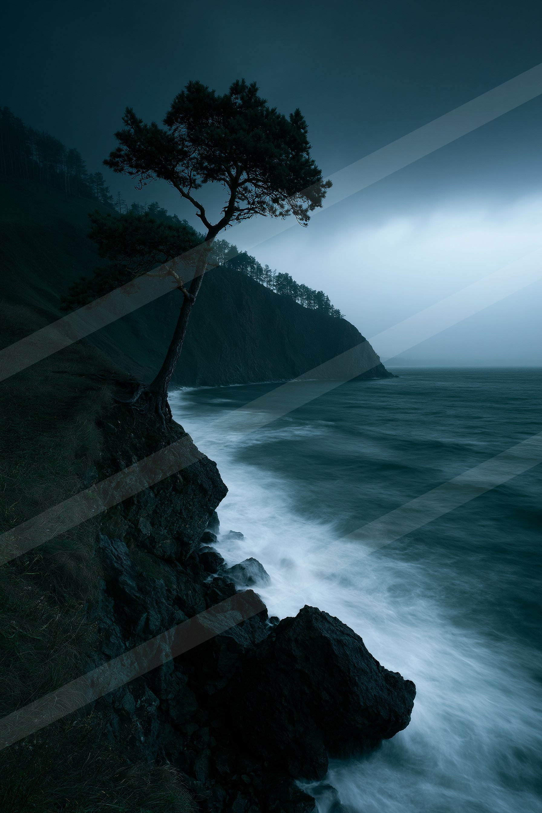 A blue hour long exposure water scene of a coastline, fog.