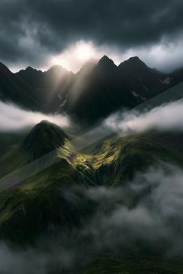 A black-and-white dramatic landscape of mountains.