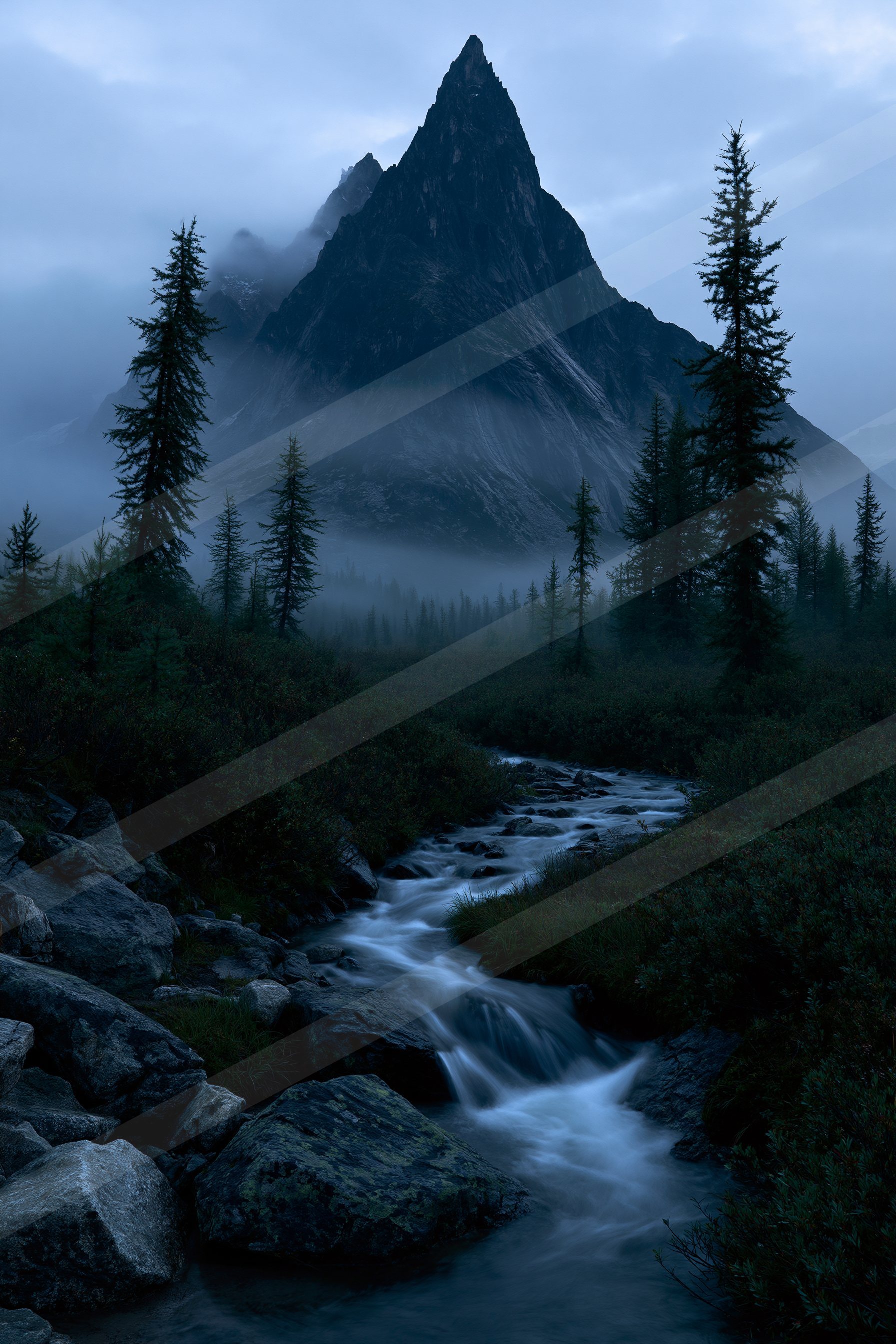 A serene mountain stream flows through a forested valley under a misty twilight sky.