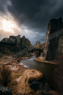 A dramatic long exposure landscape of valley, river, desert.