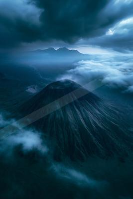 A dramatic landscape of mountains, clouds.