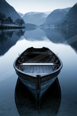 A serene still life of boat, reflection.