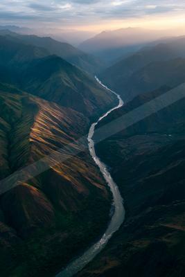 A moody water scene of river, valley.