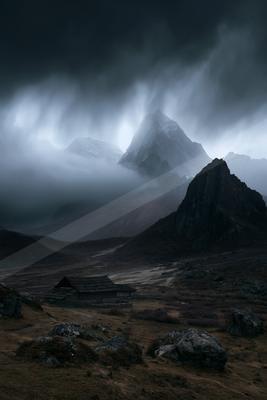 A dramatic sky scene of storm, mountains, fog.