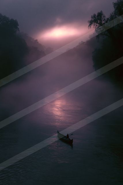 A mysterious water scene of a river, fog.