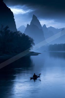 A blue-toned moody photograph of paddle, canoe, lakeside.