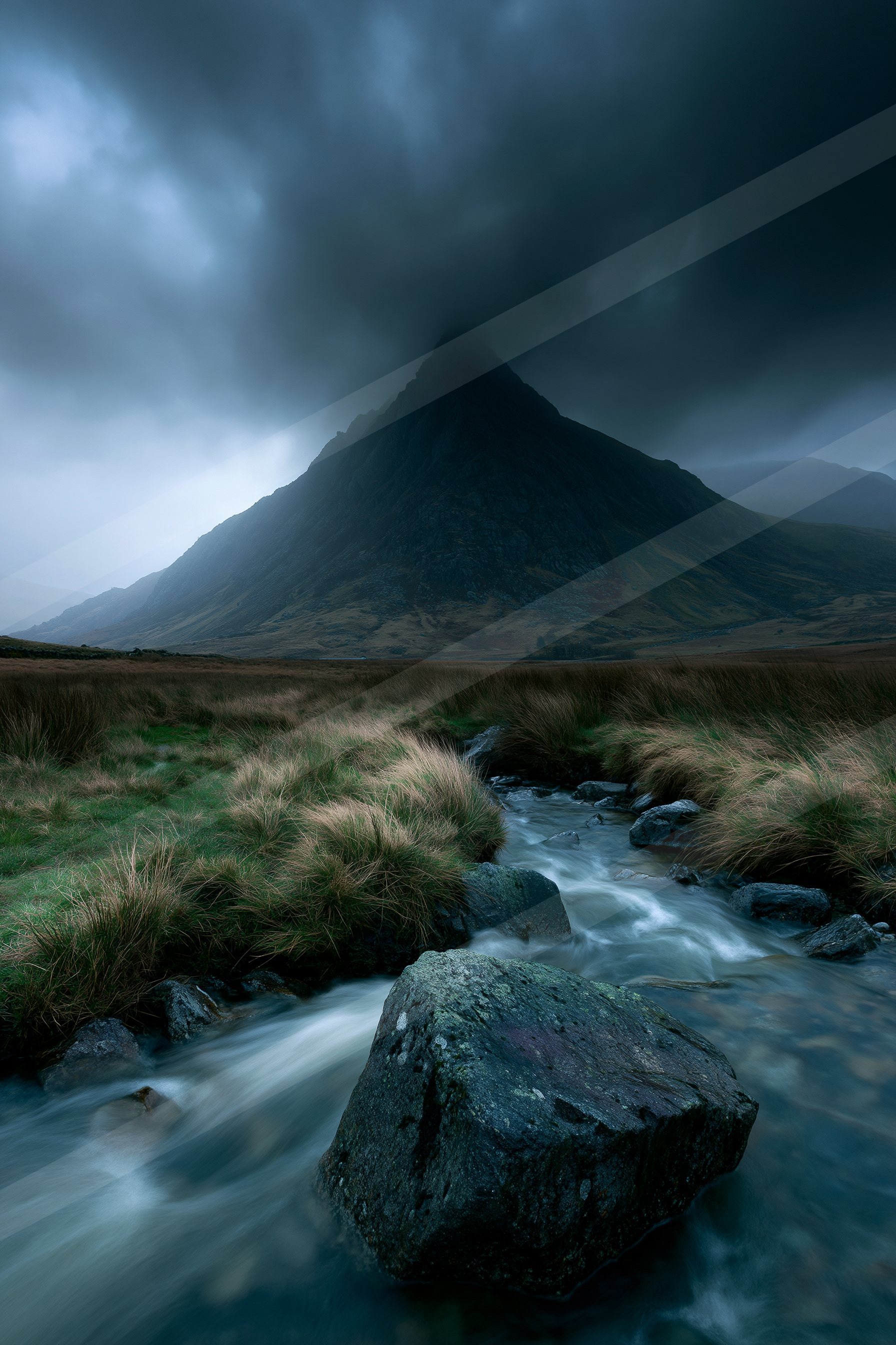 A dramatic long exposure landscape of a mountains, fog.