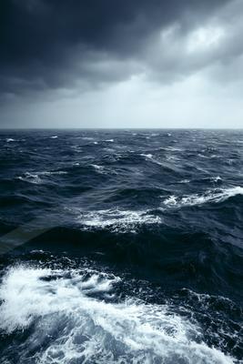 A moody high contrast water scene of an ocean, ripples.
