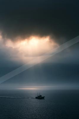 A blue hour sky scene of clouds, storm, ocean.