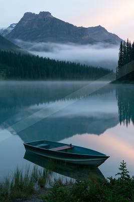 A serene water scene of lake, fog.