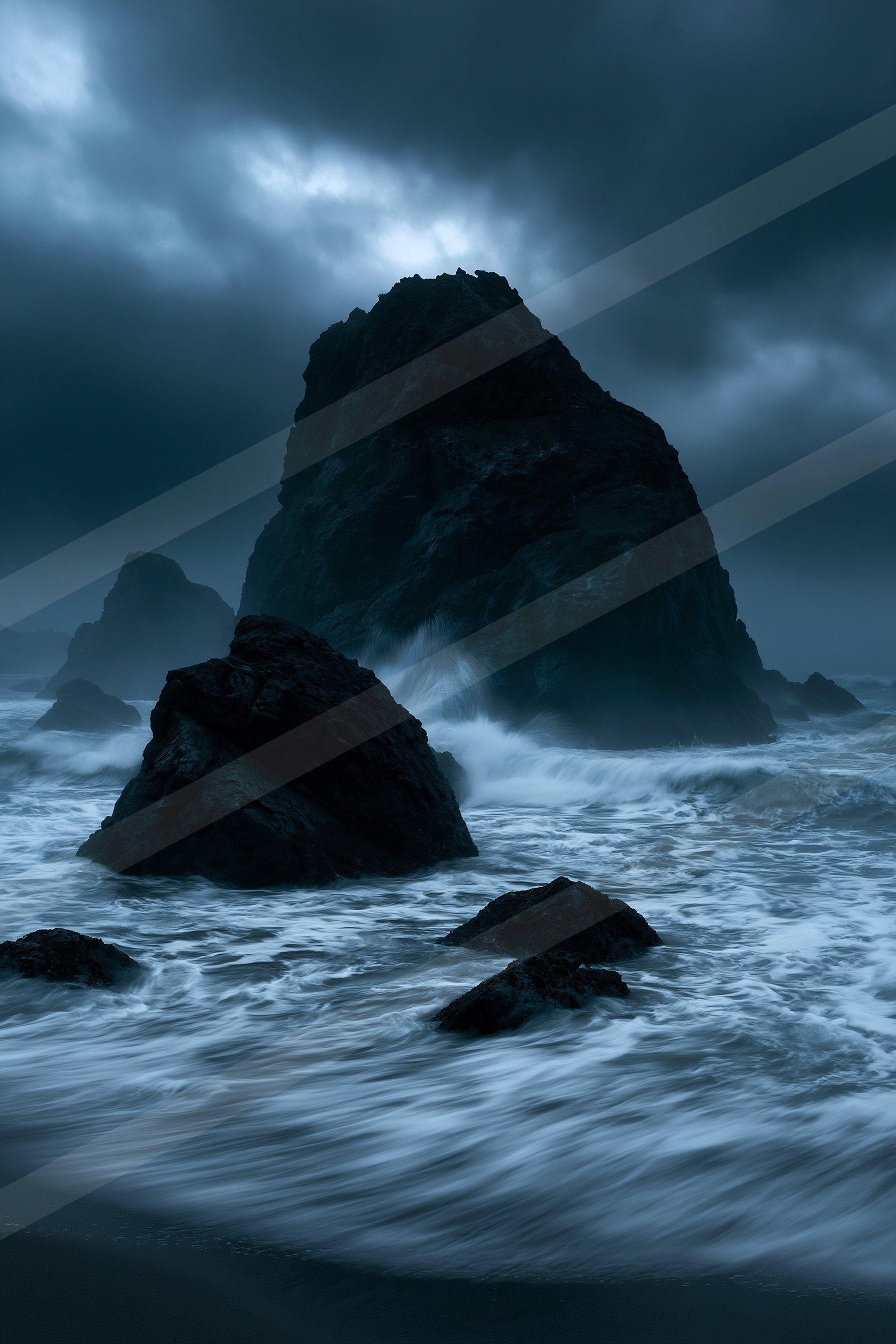 A moody long exposure water scene of an ocean, rocks.