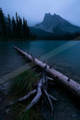 A blue hour long exposure water scene of lake, mountains.
