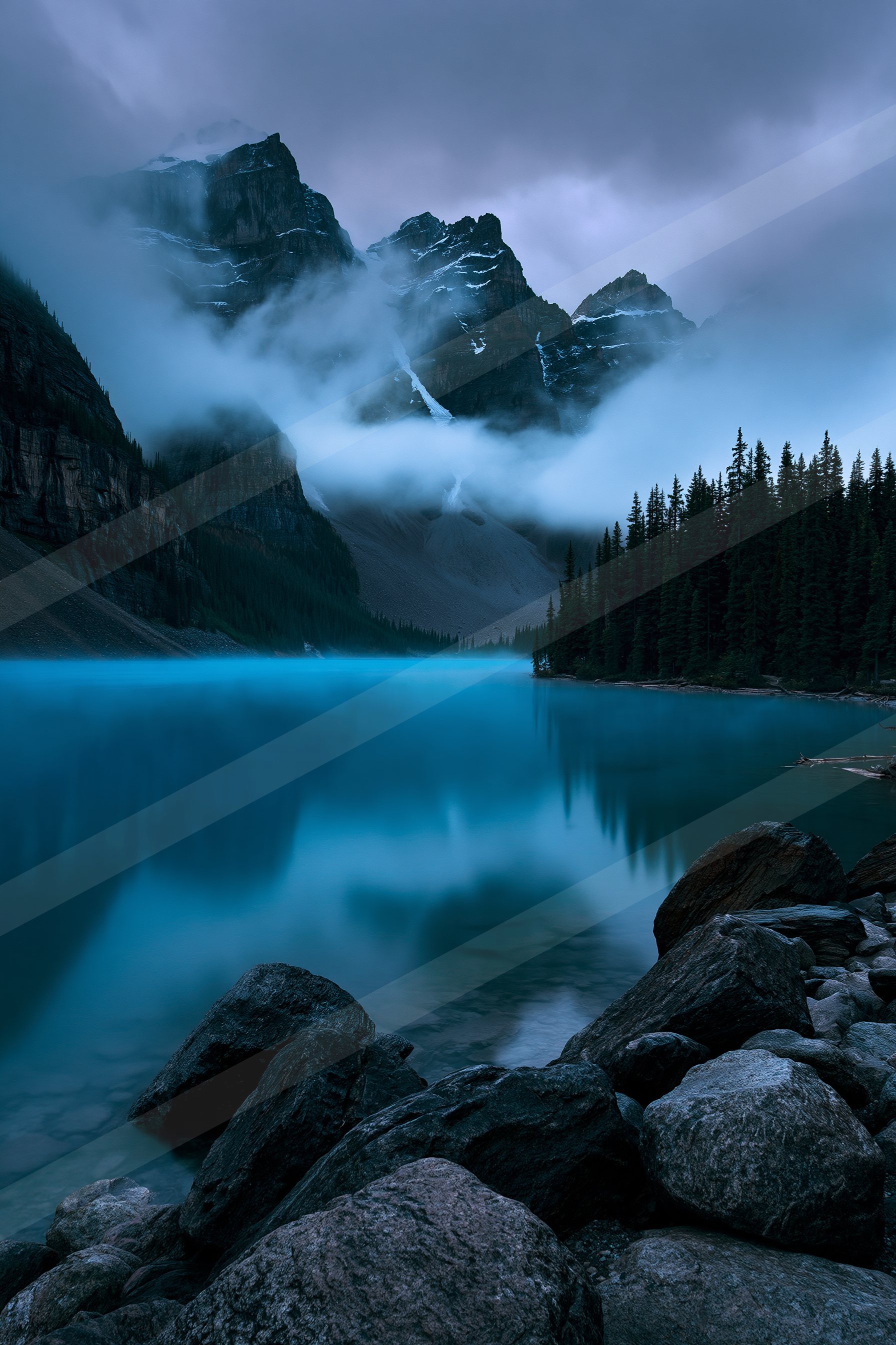 A blue hour panorama landscape of a mountains, fog.