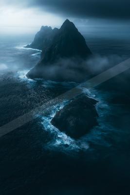 A night water scene of ocean, fog.