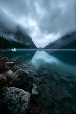 A blue hour long exposure water scene of lake, fog.