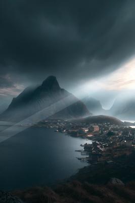 A moody landscape of mountains, storm.