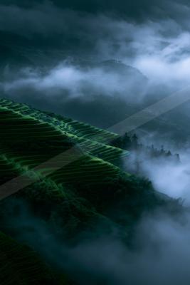 A moody landscape of valley, field, mountains.