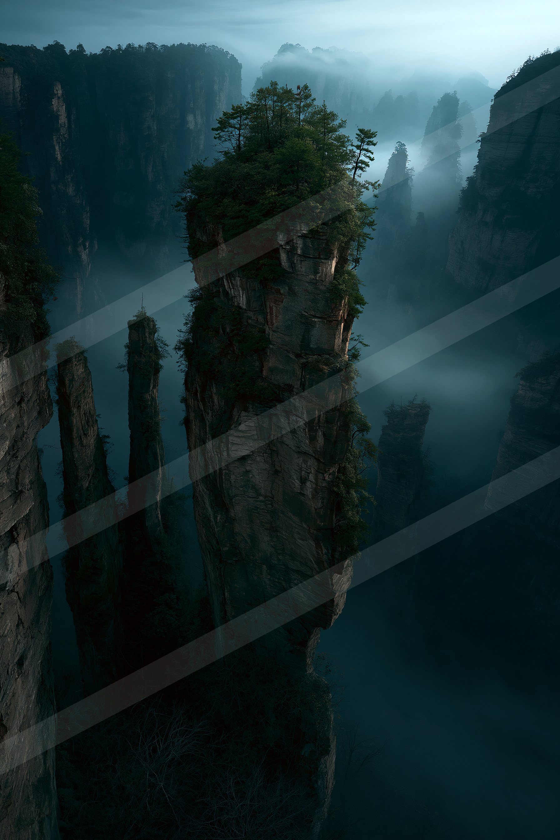 A serene mountain landscape featuring towering rock formations shrouded in mist, with lush green trees growing on the peaks.