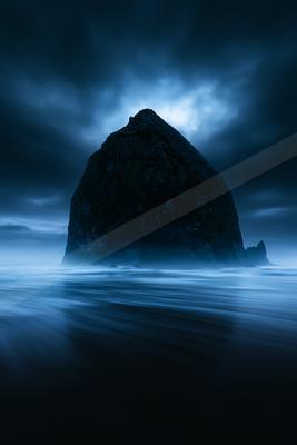 A blue hour long exposure water scene of ocean, fog.