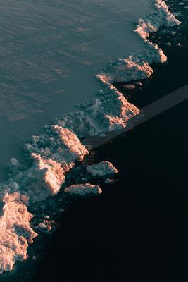 A night aerial water scene of ocean, reflection.