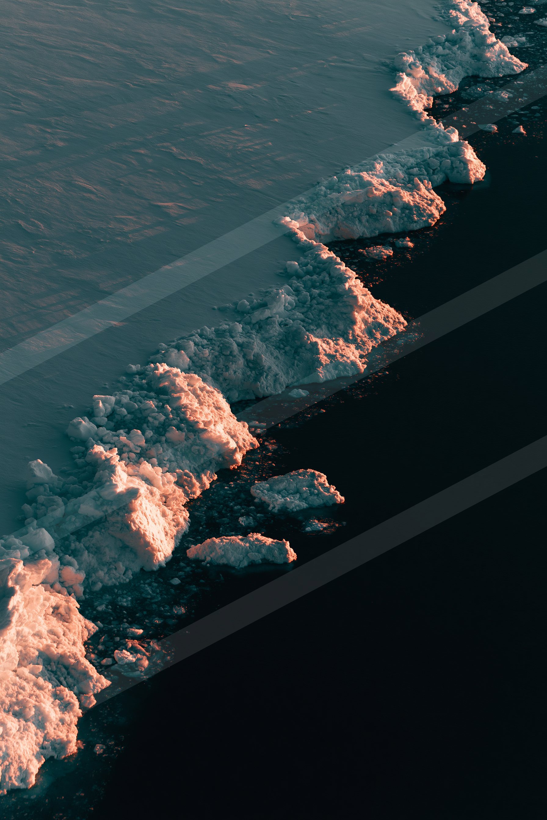 A night aerial water scene of a coastline, shadows.