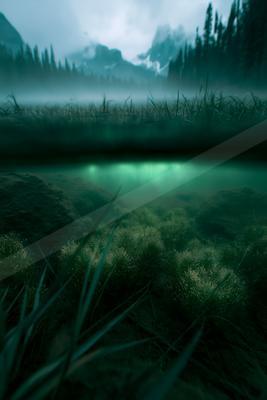 A moody water scene of lake, river, field.