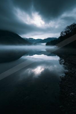 A blue hour long exposure water scene of lake, fog.