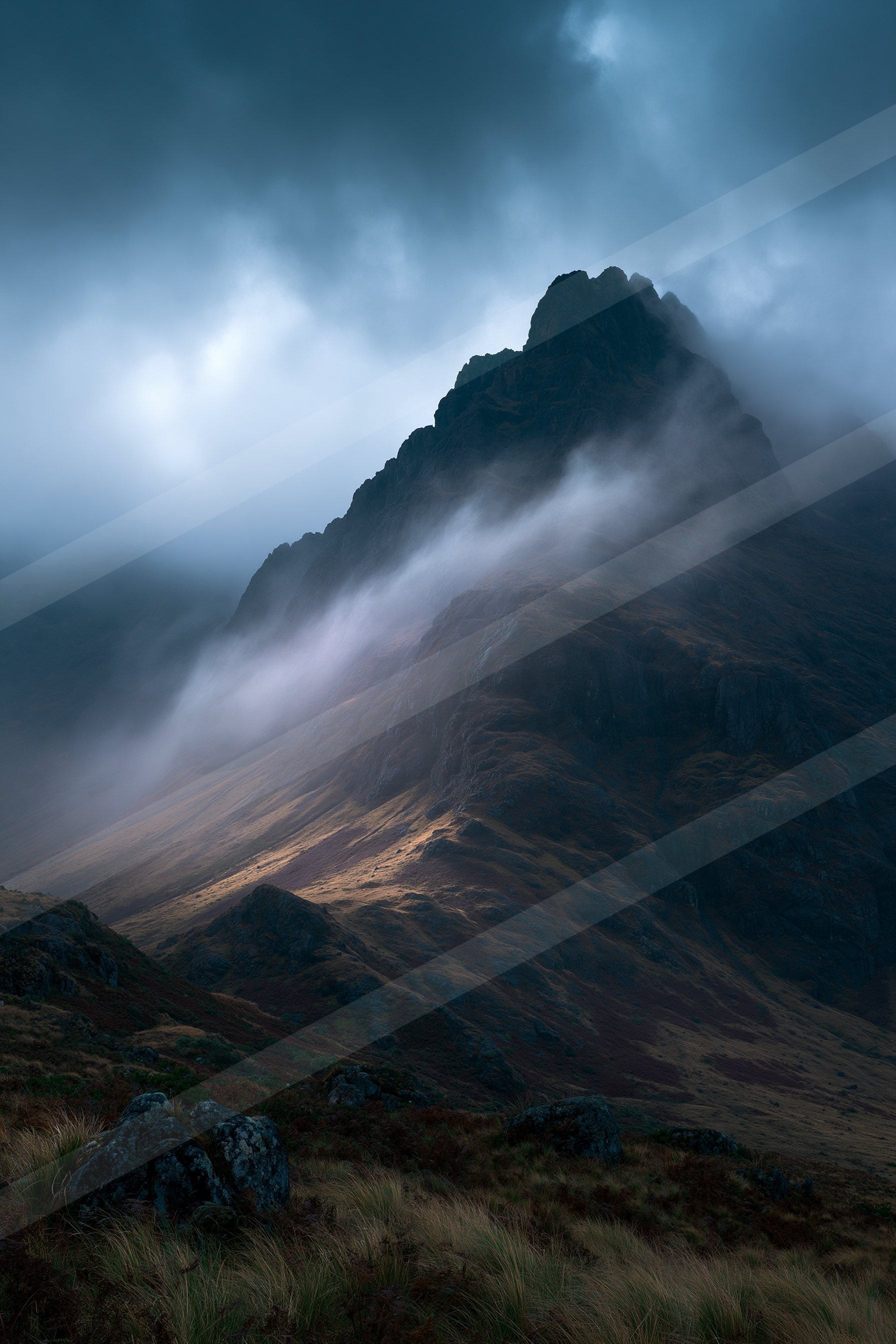 A dramatic high-key landscape of a mountains, fog.