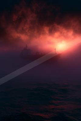 A dramatic sky scene of sunrise, storm, ocean.