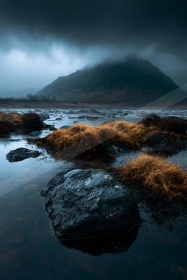A dramatic long exposure water scene of lake, mountains, river.