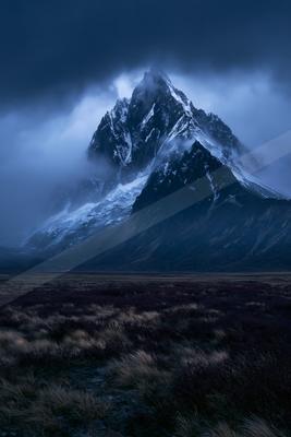 A black-toned moody photograph of volcano, alp, valley.