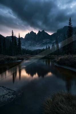 A night long exposure water scene of lake, mountains, valley.