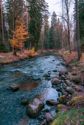 A serene long exposure water scene of river, rocks.