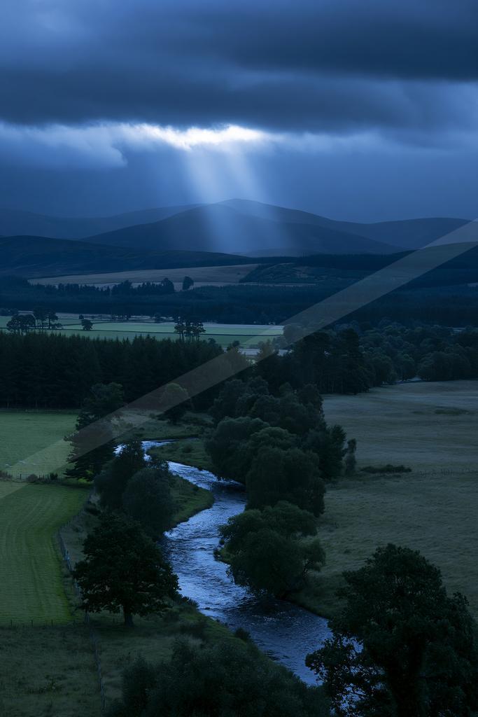A night water scene of river, valley, storm.