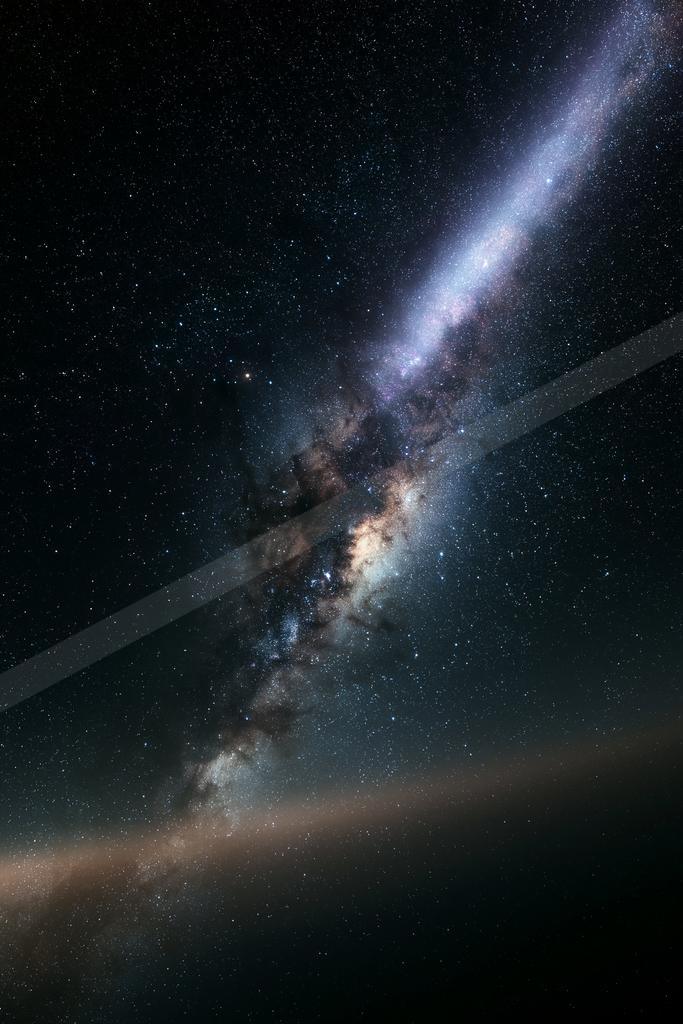 Vibrant view of the Milky Way galaxy stretching diagonally across a star-filled night sky with dark dust lanes and colorful nebulosity