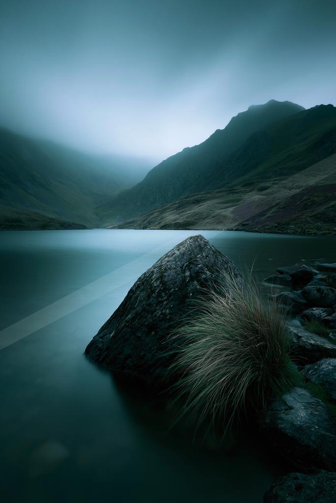 A blue hour long exposure water scene of lake, fog.
