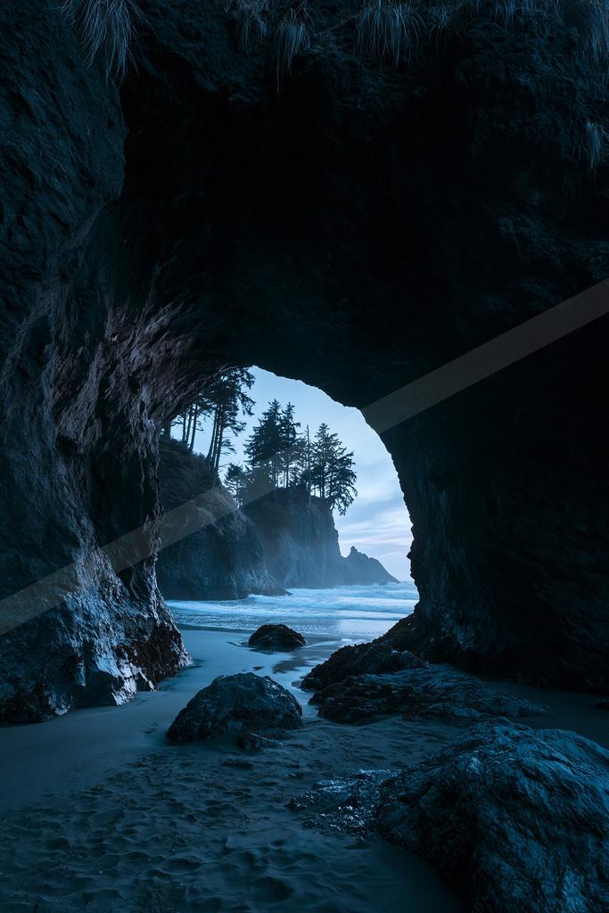 A blue hour water scene of beach, ocean.