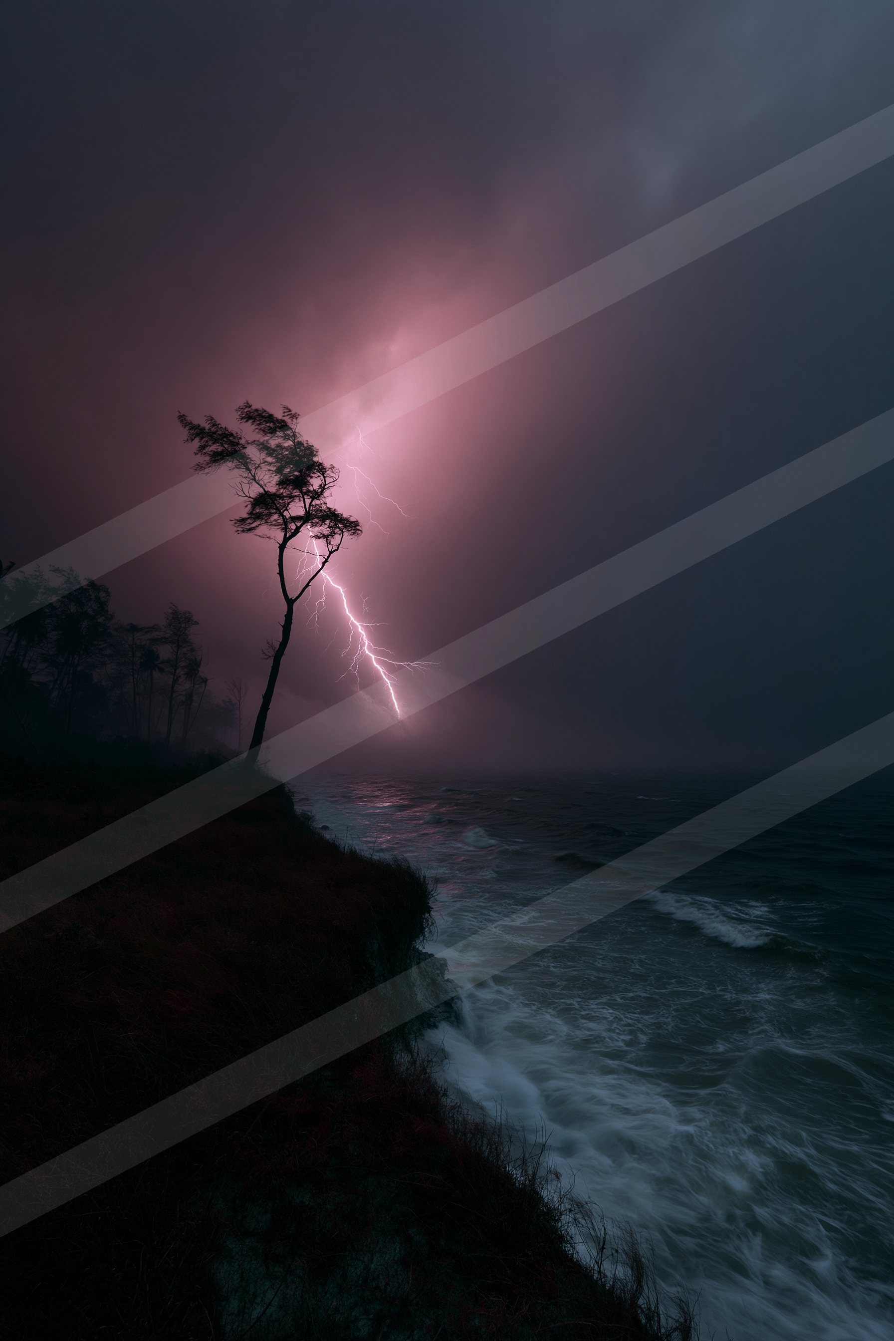 A lone tree silhouetted against a stormy sky with a striking lightning bolt illuminating the scene over the ocean.