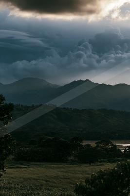 A dramatic sky scene of storm, clouds, mountains.