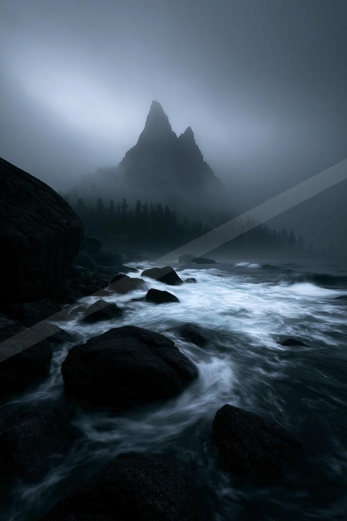 A night landscape of mountains, ocean, waterfall.