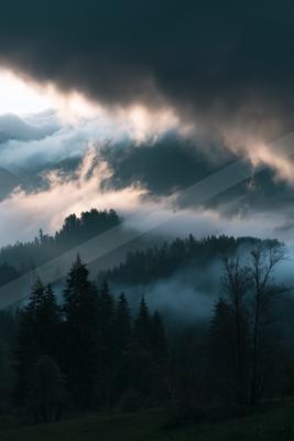 A brown-toned moody photograph of alp, valley, lakeside.