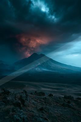 A blue hour high contrast landscape of a volcano, dust.