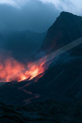 A dramatic landscape of a volcano, fire.