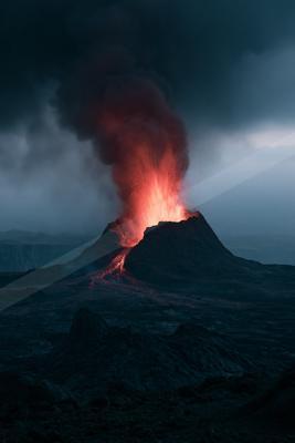A powerful volcanic eruption at night, with bright red lava exploding from the crater and flowing down the mountainside, billowing dark smoke into the sky.