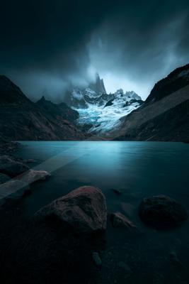 A night long exposure landscape of mountains, lake.