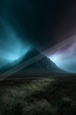 A dramatic landscape of mountains, storm, fog.