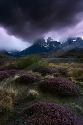 A dramatic landscape of mountains, valley, storm.