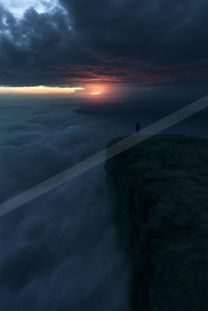 A blue hour sky scene of sunrise, clouds, fog.